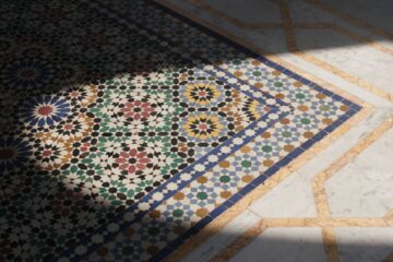 A Mosaic of Multitude Intricate Moroccan mosaic tile flooring design with shadow contrast and vibrant colors.